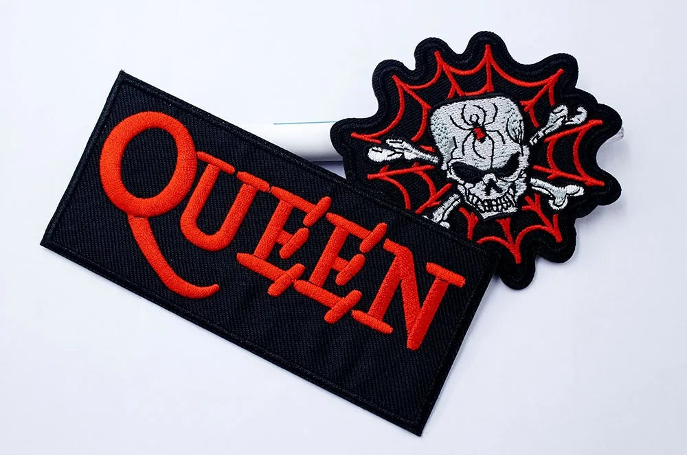 Two patches, one with 'QUEEN' text and the other with a skull design, on a white background.