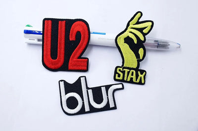 Three patches with 'U2', 'Stax', and 'blur' logos on a white background.