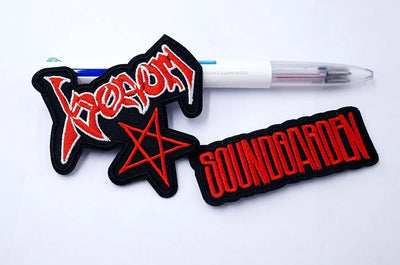 Two patches with 'Korn' and 'Soundgarden' logos on a white background.