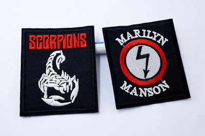 Two embroidered patches, one with Scorpions logo and the other with Marilyn Manson logo, on a white background.