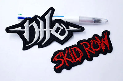 Two patches, one with a stylized 'DIO' logo and the other with 'SKID ROW' text, on a white background.