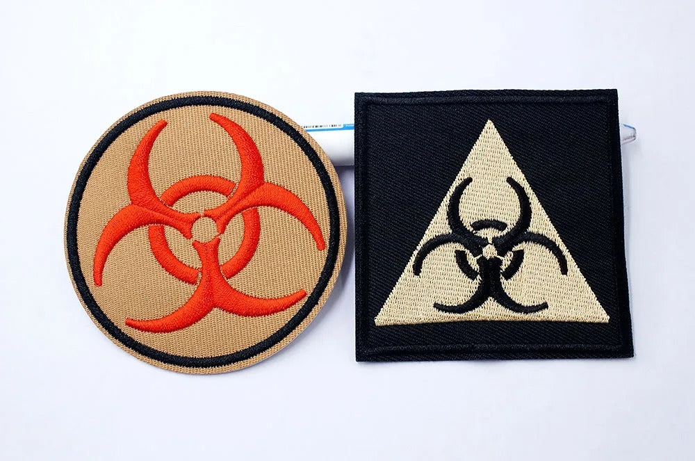 Two biohazard symbol patches on a white background
