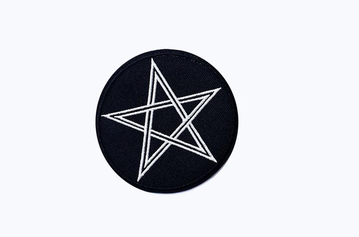 Black circular patch with a white star design on a white background