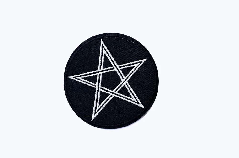 Black circular patch with a white star design on a white background