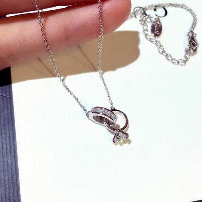 a hand holding Silver Diamond Inlaid Clavicle Necklace
