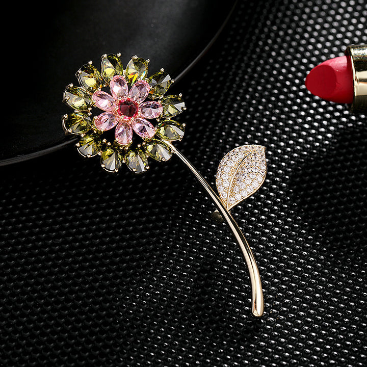 Decorative brooch with floral design on a textured black surface