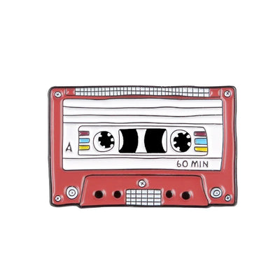 enamel pin of a Red cassette tape with a white label on a white background