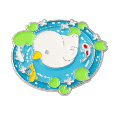 enamel pin of a duck swimming in a pool with fish on a white background