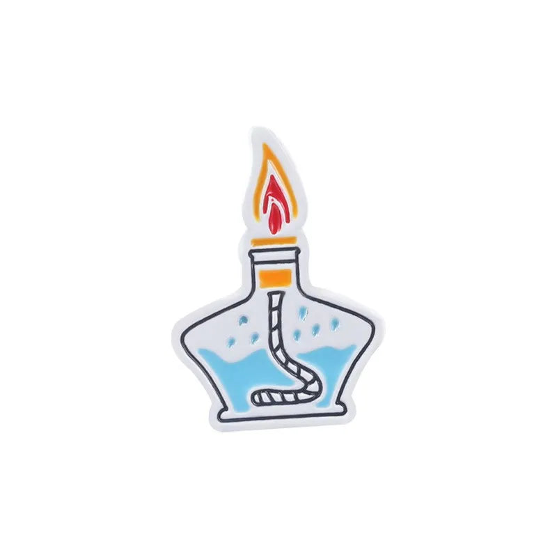 enamel pin of a lit Bunsen burner with blue liquid on a white background