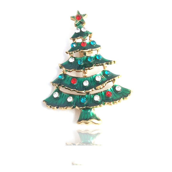 Christmas tree-shaped brooch with colorful gemstones on a white background