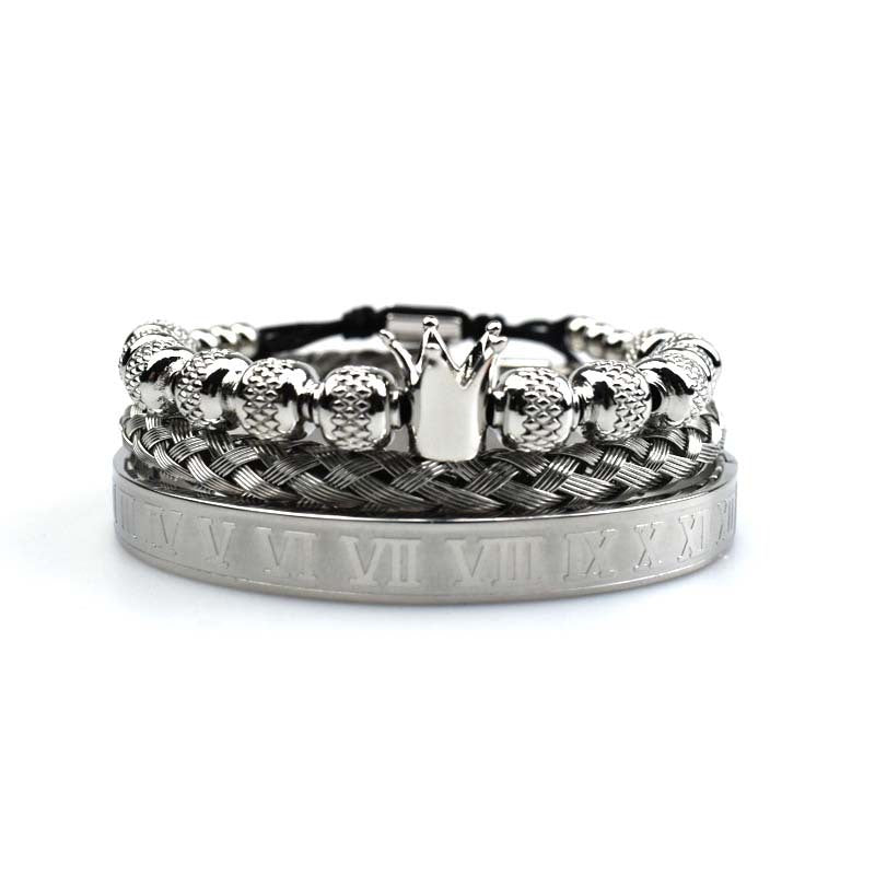 Silver bracelet with crown design on a white background