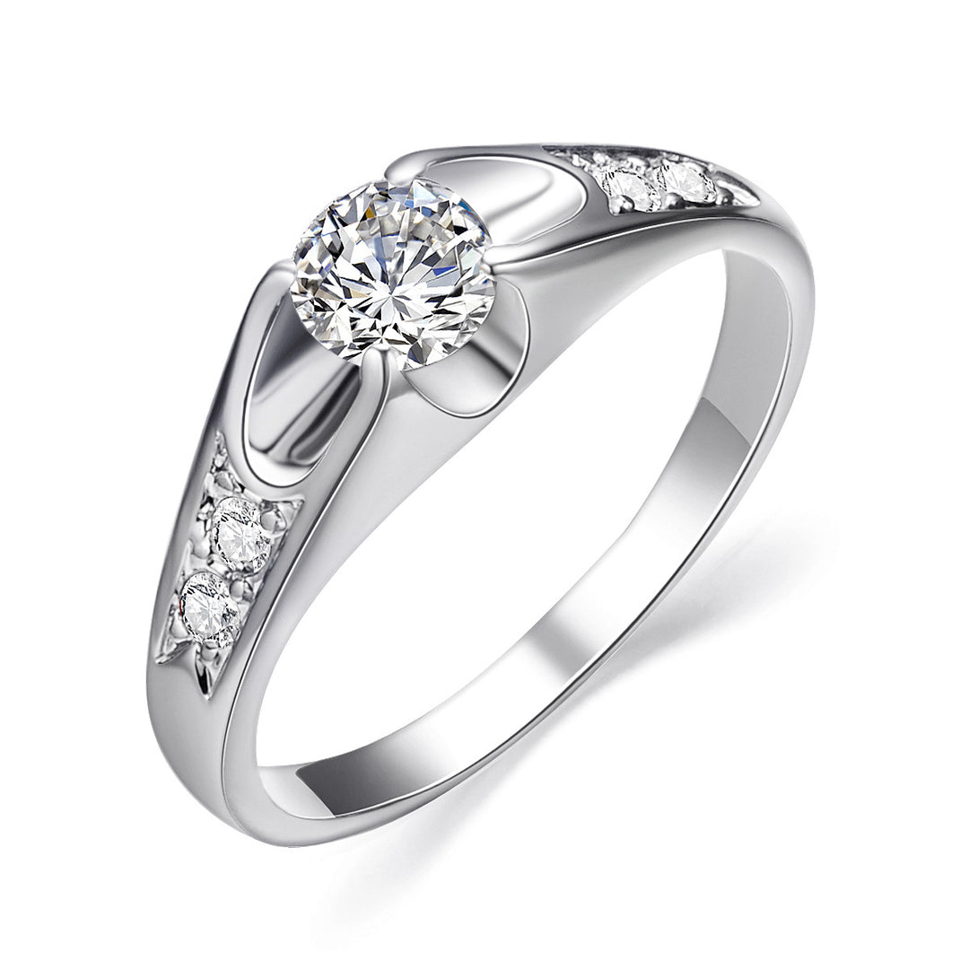 Silver ring with a central zircon and smaller zircons on the band against a white background