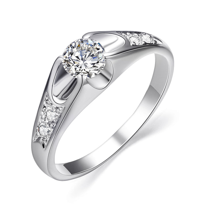 Silver ring with a central zircon and smaller zircons on the band against a white background