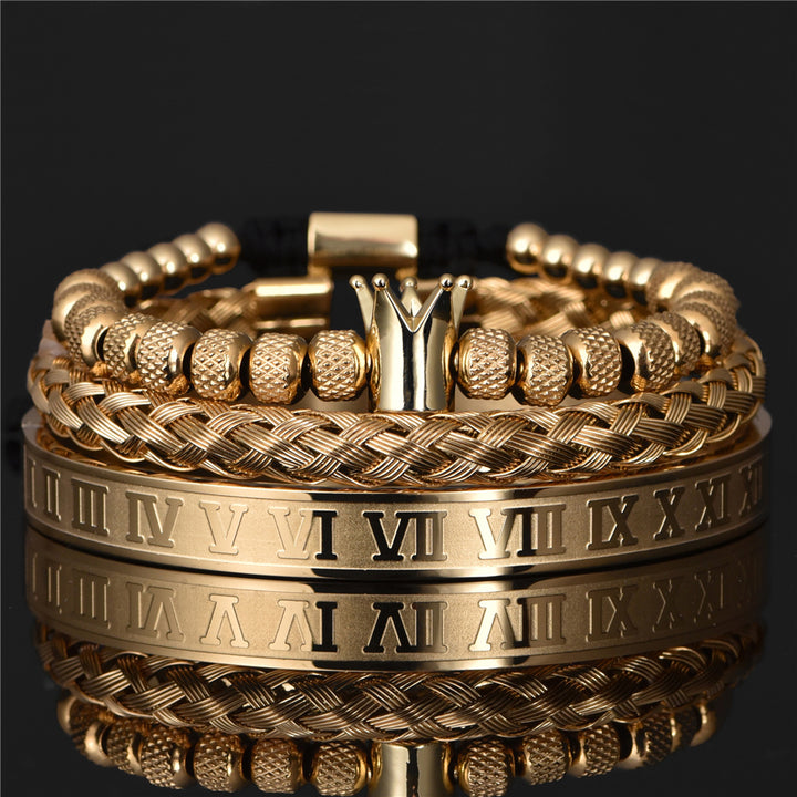 Gold bracelets with Roman numeral design on a black background