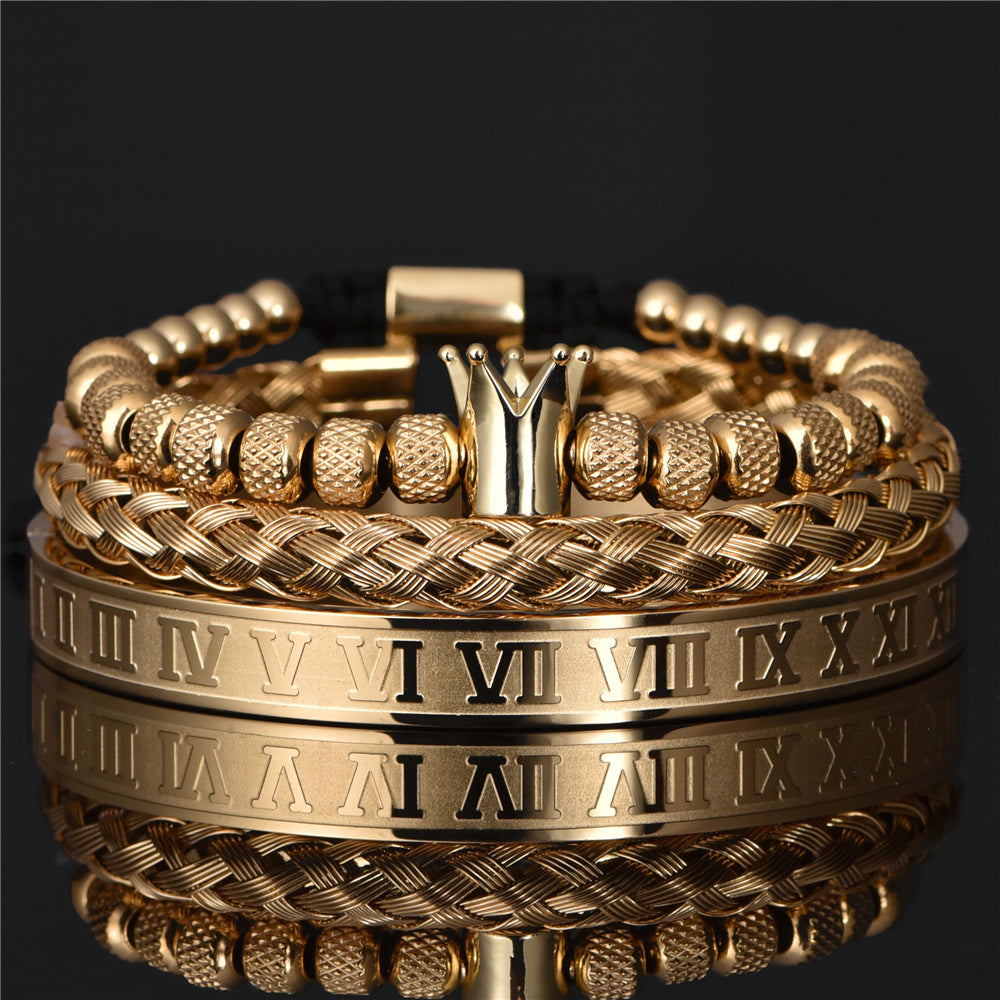 Gold bracelets with Roman numeral design on a black background