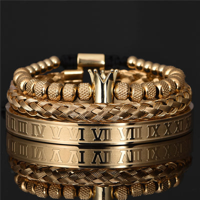 Gold bracelets with Roman numeral design on a black background