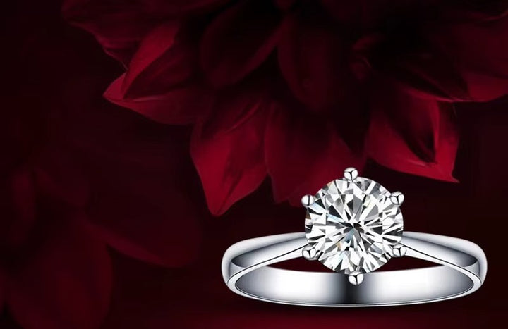 Diamond ring on a dark background with red flowers