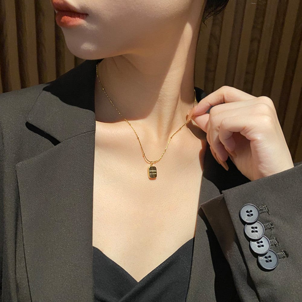 a woman wearing Letter Double Sided Gold Coin Necklace Female Minority Design