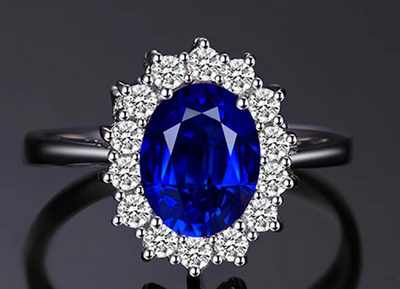 Ring with a blue gemstone and diamond halo on a dark background