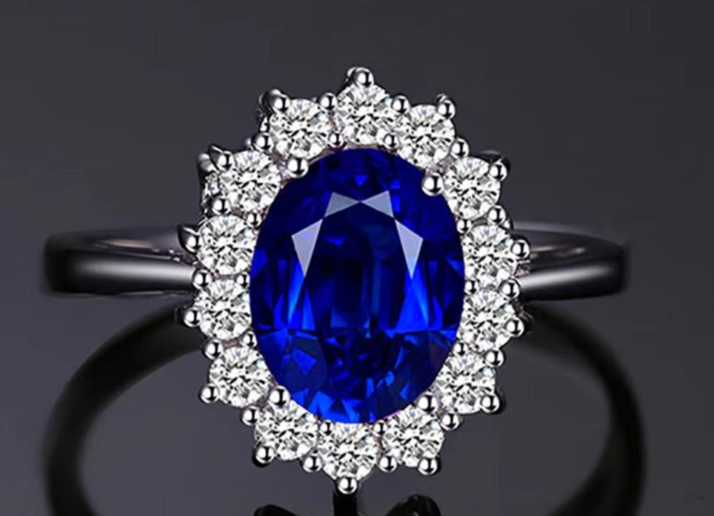 Ring with a blue gemstone and diamond-studded halo on a dark background