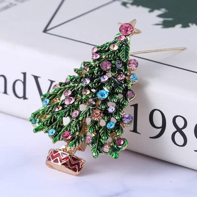 meiberry jewelry christmas tree brooch leaning on a book