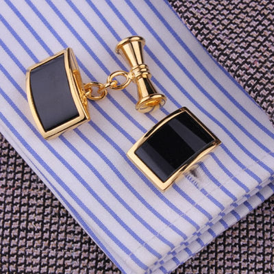 black and gold Cufflinks on striped light blue and white shirt