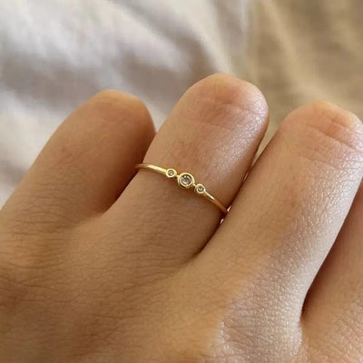 a woman wearing  Minimal Zircon ring on her left ring finger