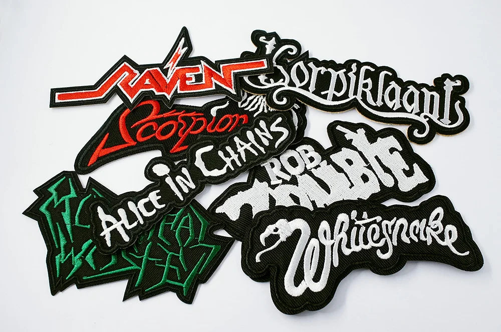 Collection of music band logo patches on a white background