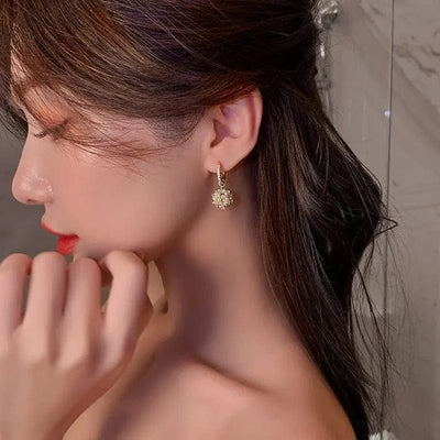 a woman wearing Gold Pearl drop earrings