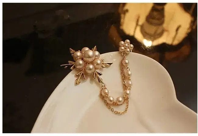 BROOCHITON Brooches Gold Pearl Flower Brooch on edge of a beige plate
