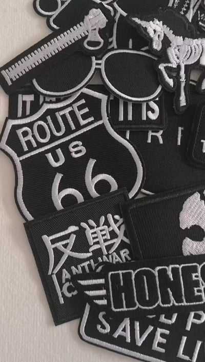 Video of a Collection of black and white patches with various designs and text.