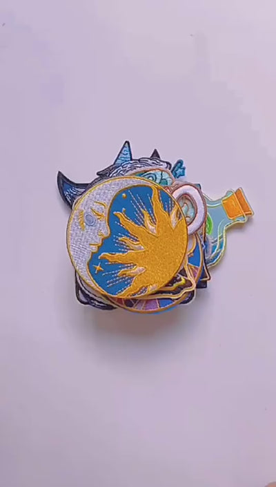 video of a Collection of colorful embroidered patches with various designs on a white background