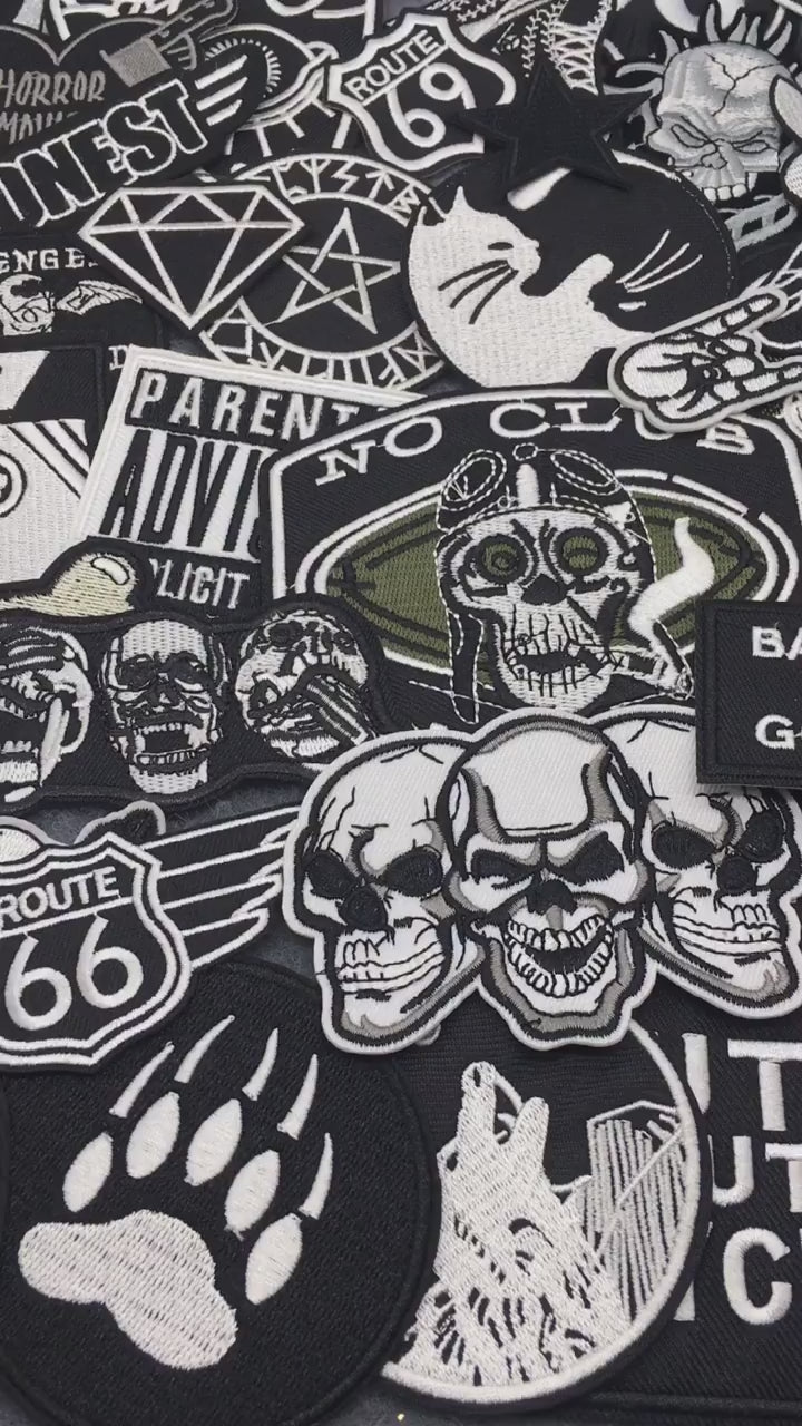 video of a Collection of various black and white stickers on a gray 
