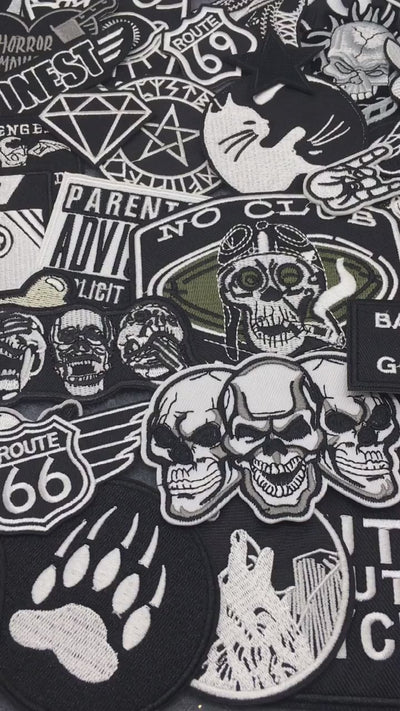 video of a Collection of various black and white stickers on a gray 