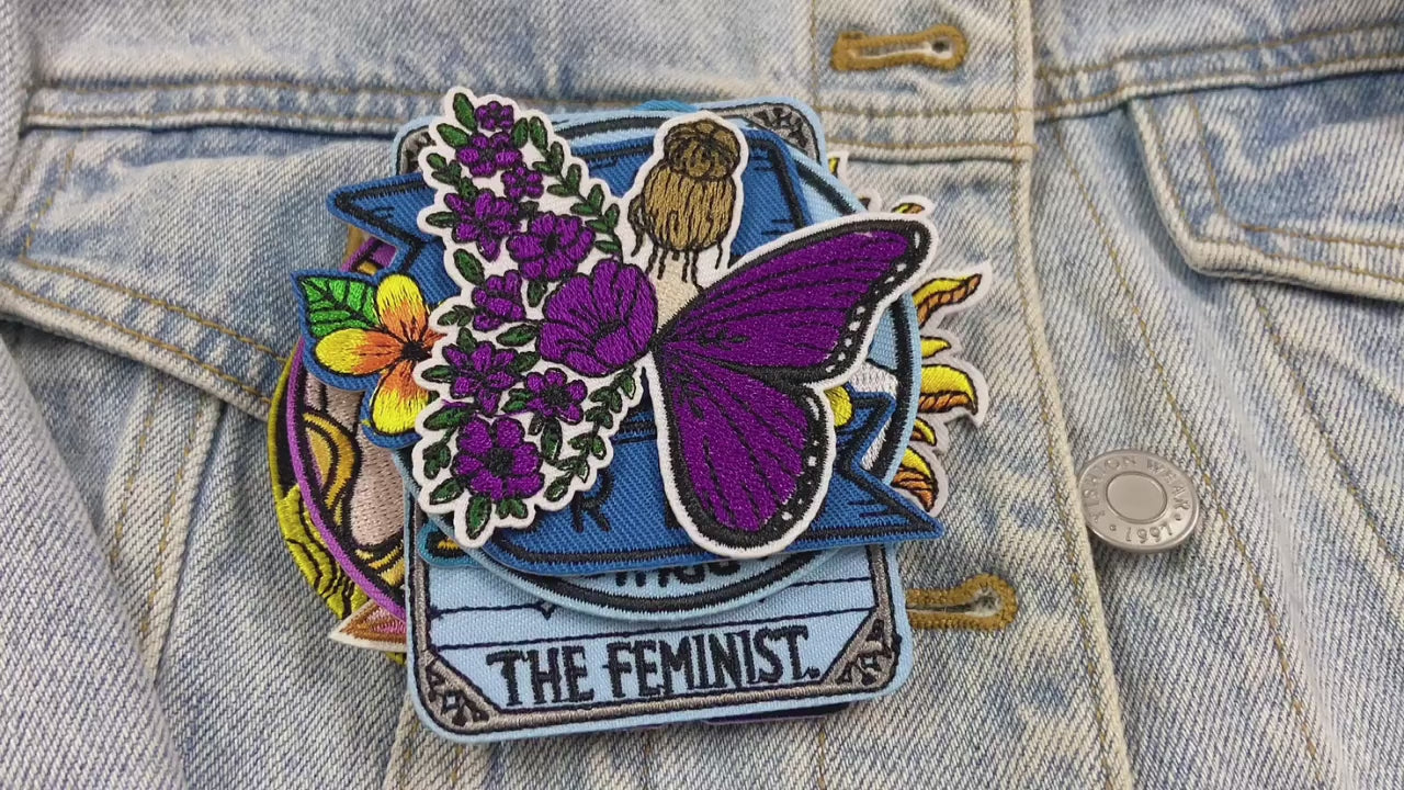 video showing a Collection of colorful patches with various designs and text on a denim background