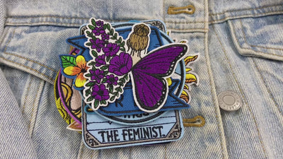 video showing a Collection of colorful patches with various designs and text on a denim background