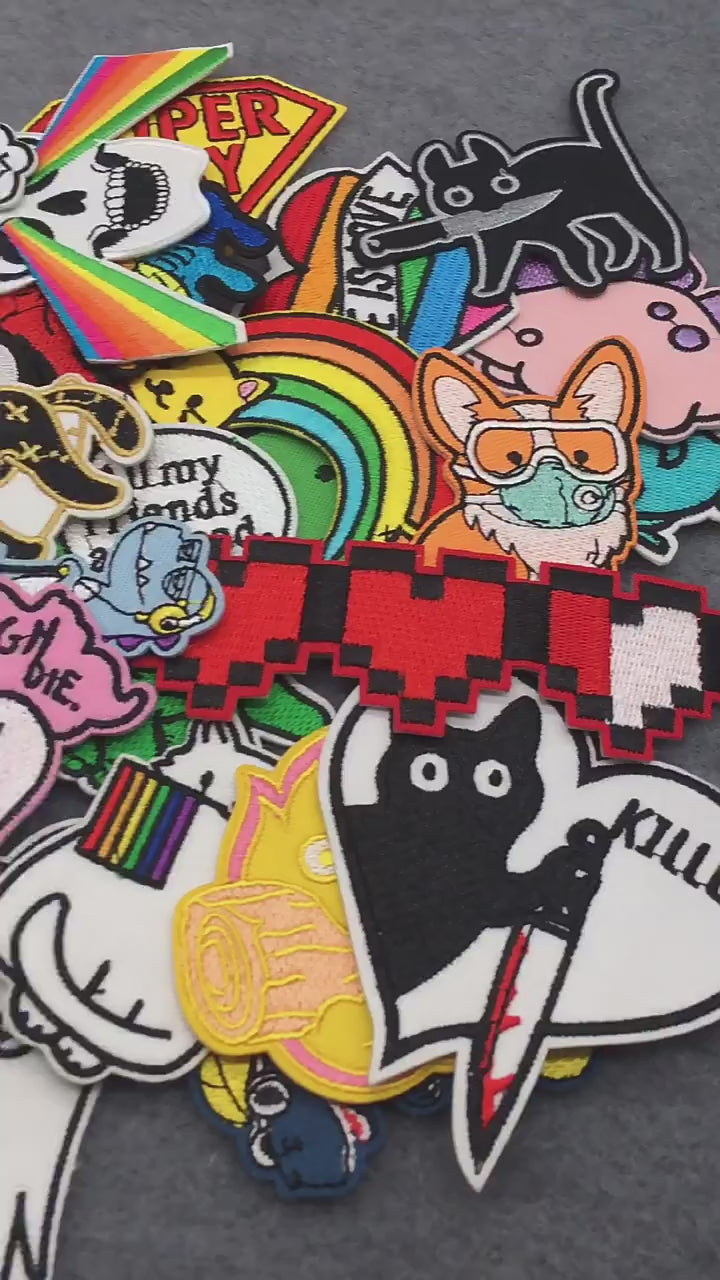 video of a Collection of colorful patches with various designs on a dark 
