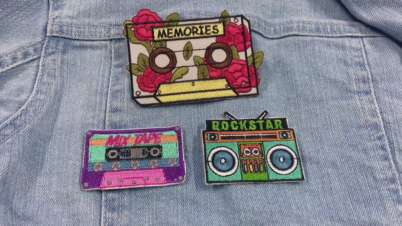 video demonstrating a Collection of colorful embroidered patches with various designs on a denim background