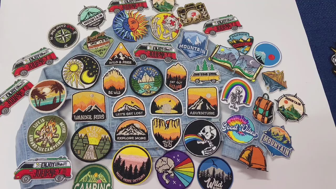 video of a Collection of outdoor-themed patches on a denim fabric 