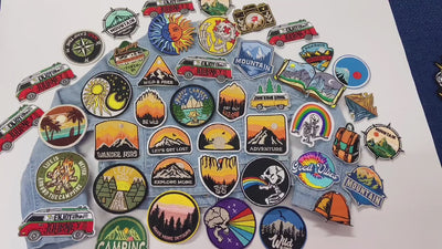 video of a Collection of outdoor-themed patches on a denim fabric 