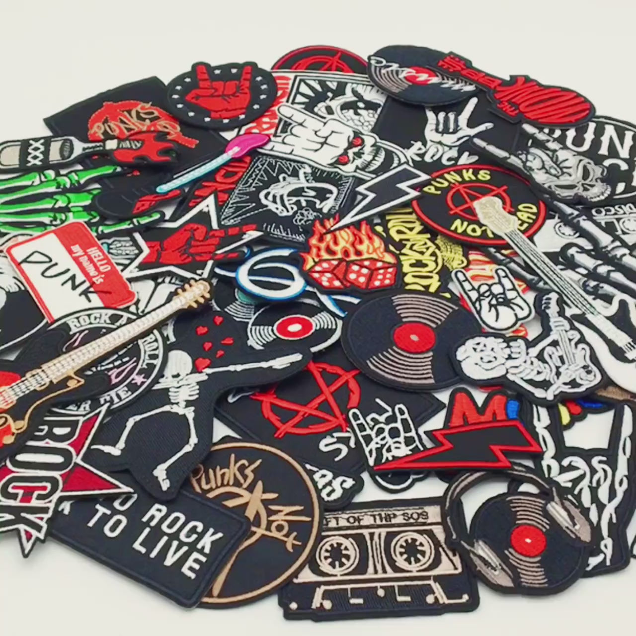 Video of a Collection of punk-themed patches with various designs on a white background.