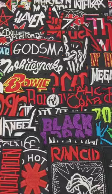 video of a Collection of various band patches with prominent text on a black background