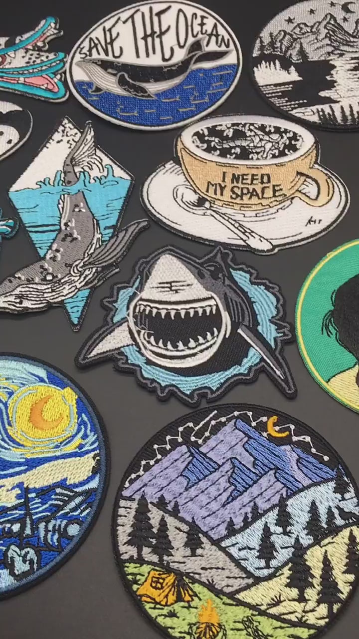 Video of a Collection of various embroidered patches on a dark background