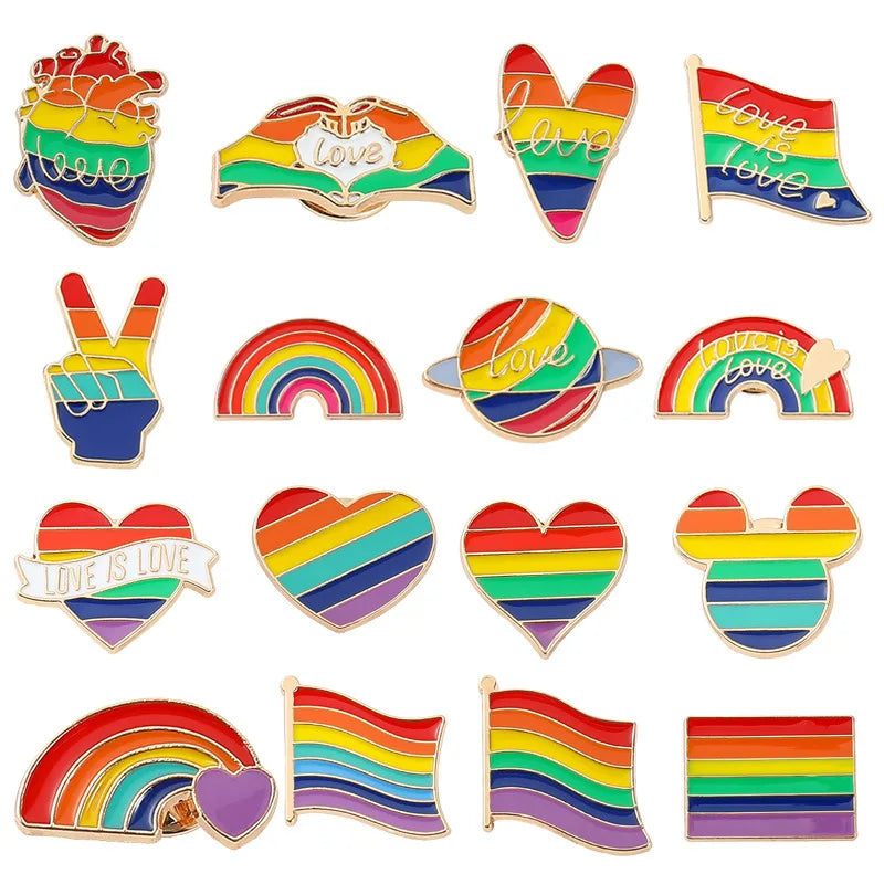 Collection of rainbow-themed pins and badges on a white background
