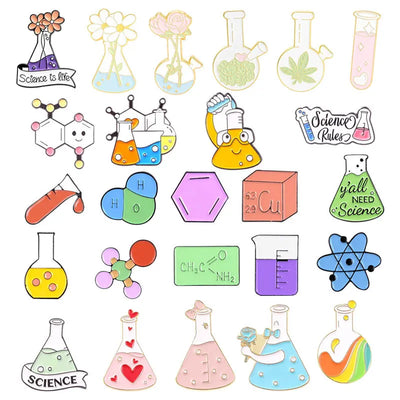 set of colorful science-themed enamel pins on a white background