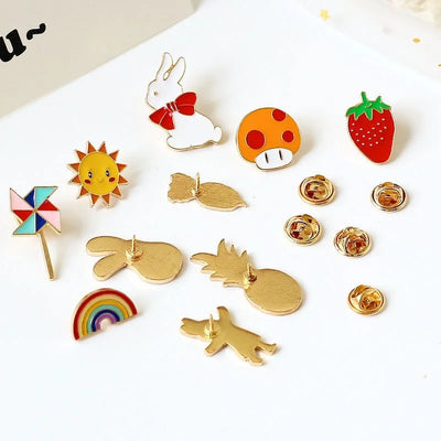 Collection of colorful pins including a sun, rainbow, rabbit, mushroom, and more on a white background.
