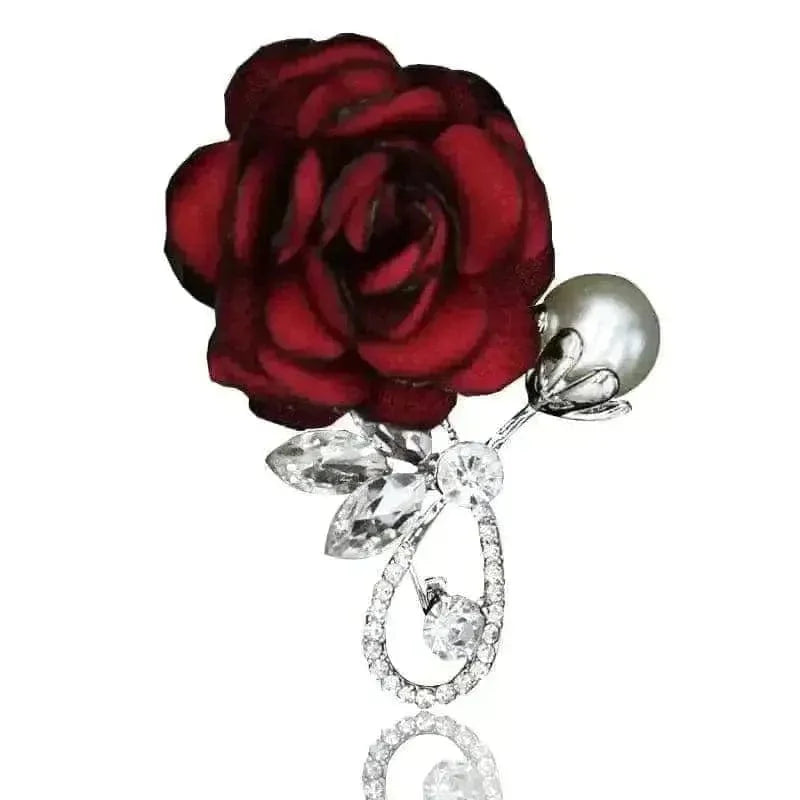 red rose with a ear and diamond look brooch