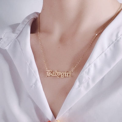 woman wearing rose gold Stainless Steel Baby Girl Necklace Old EnglishBROOCHITON Necklaces Stainless Steel Baby Girl Necklace Old English Letter Pendants Choker