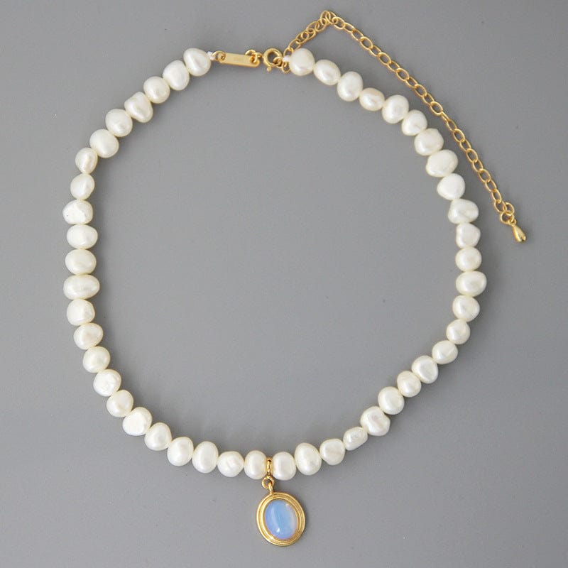irregular pearl silver necklace on a grey background