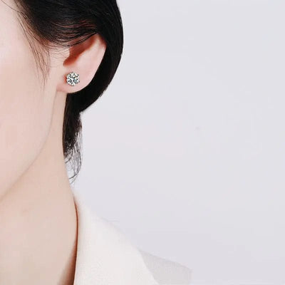 a woman wearing s925 sterling silver six-claw ear studs